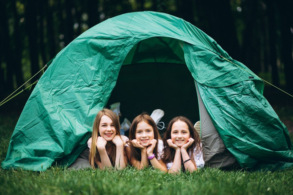 Group of girls camping in forest